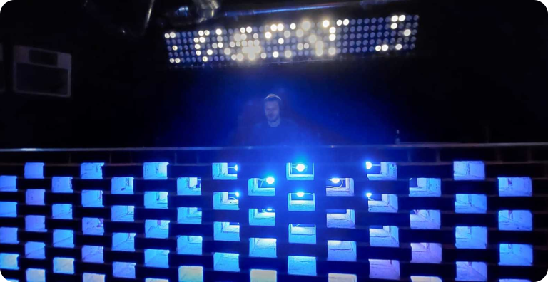 DJ plays music at Loft Vienna, with modern DJ equipment and atmospheric lighting.